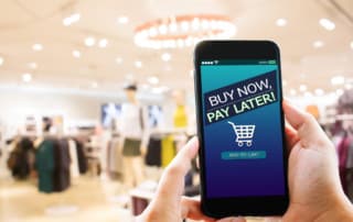 In a department store, a close up of the buy now pay later option on a mobile phone