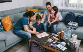 Mother and father explaining money and a budget to their kids