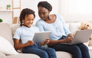 Black mother watching her daughter's activity online.